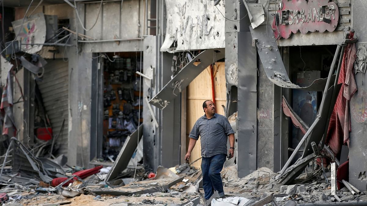 A Palestinian man views the damage in the aftermath of Israeli air strikes that destroyed a tower building, amid a flare-up of Israeli-Palestinian violence. Credit: Reuters Photo