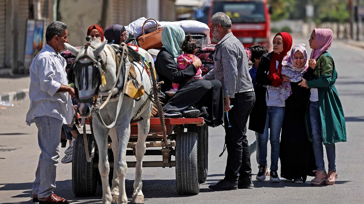 Members of a Palestinian family prepare to ride a carriage.