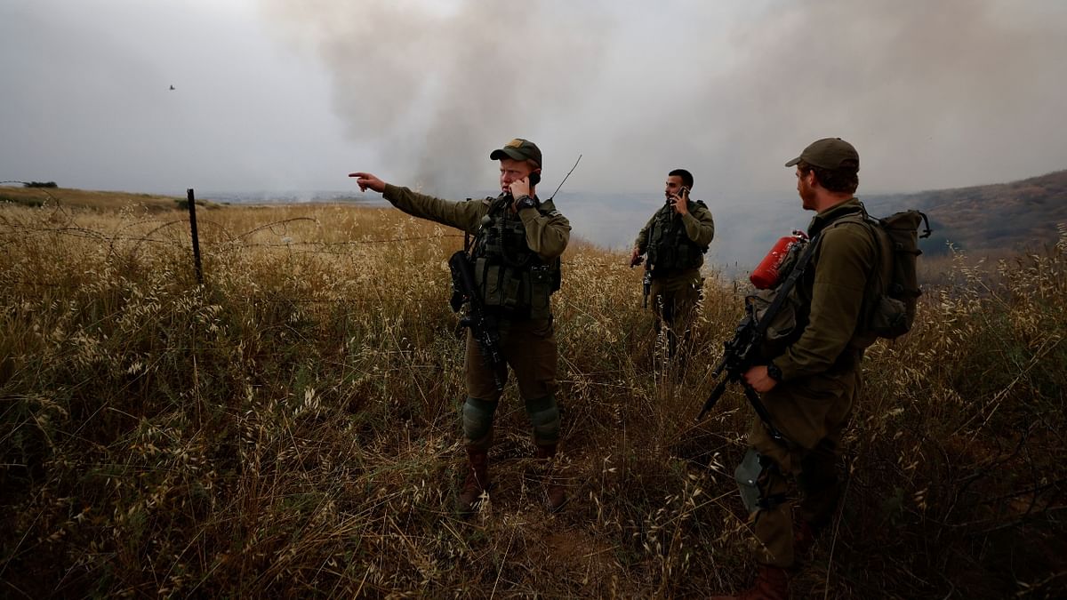 Israeli soldiers fight fire, after Palestinians in Gaza sent incendiary balloons over the border, near Nir Am, southern Israel.