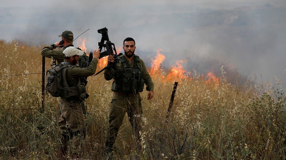 Israeli soldiers fight fire, after Palestinians in Gaza sent incendiary balloons over the border, near Nir Am, southern Israel.