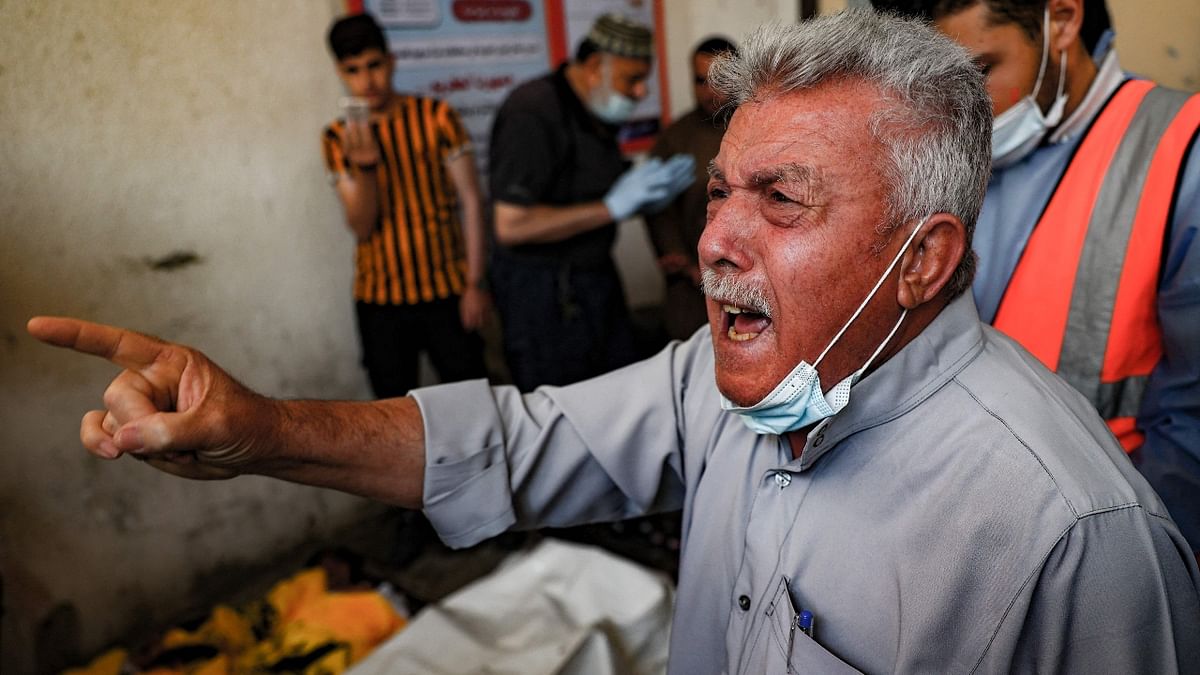 The grandfather who lost his three children in a reported Israeli air strike, reacts at his residence before their burial in Beit Lahya in northern Gaza strip.