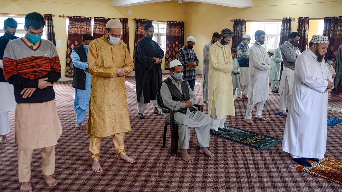 Muslim devotees offer prayers on the occasion of Eid-ul-Fitr to mark the end of Ramadan at their residence in Srinagar.