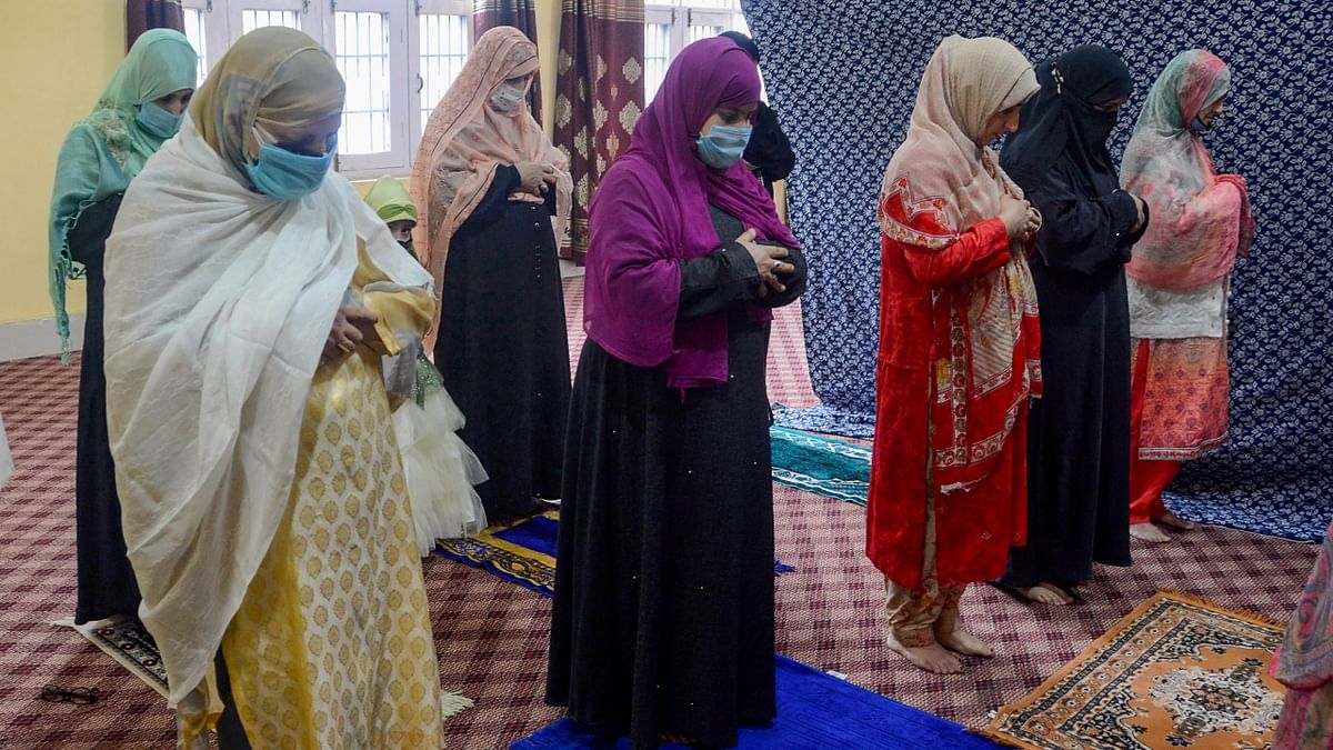 Muslim devotees offer prayers on the occasion of Eid-ul-Fitr to mark the end of Ramadan at their residence in Srinagar.
