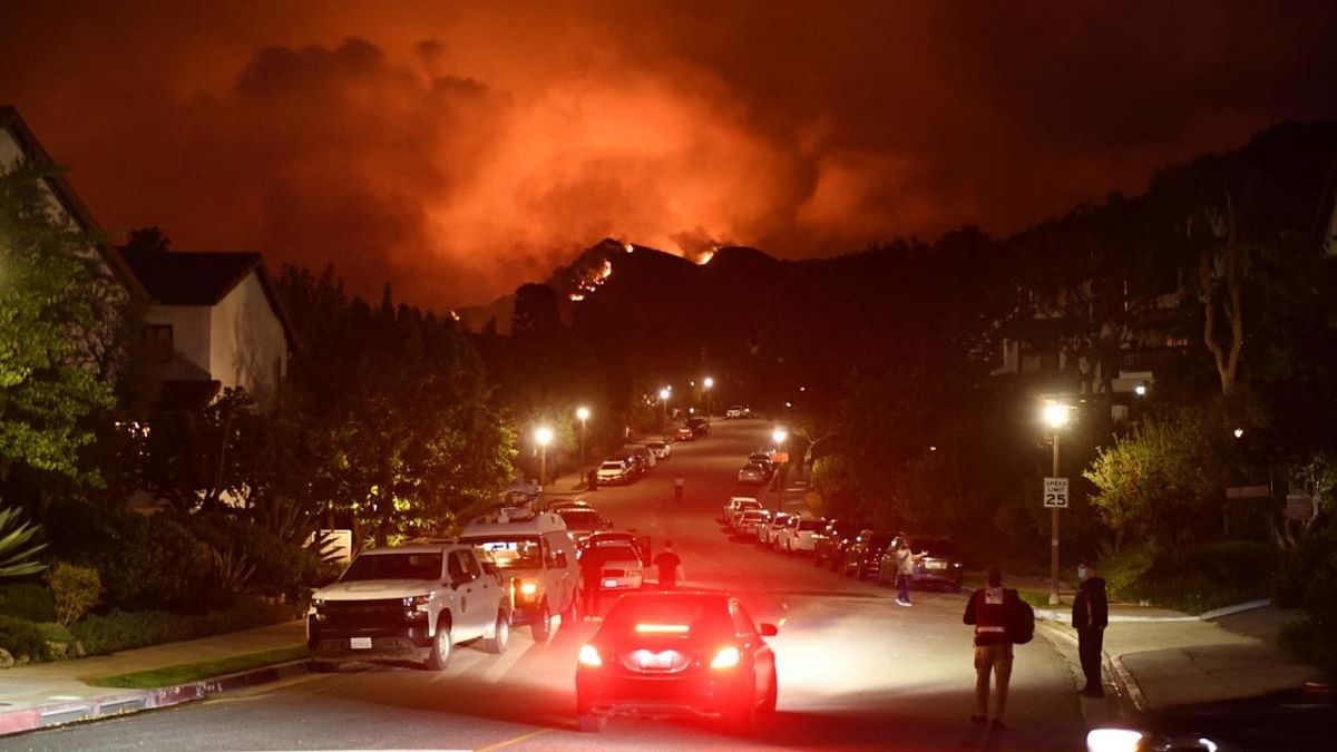 Flames from the Palisades Fire glow in the distance in Topanga, northwest of Los Angeles. Credit: AFP Photo