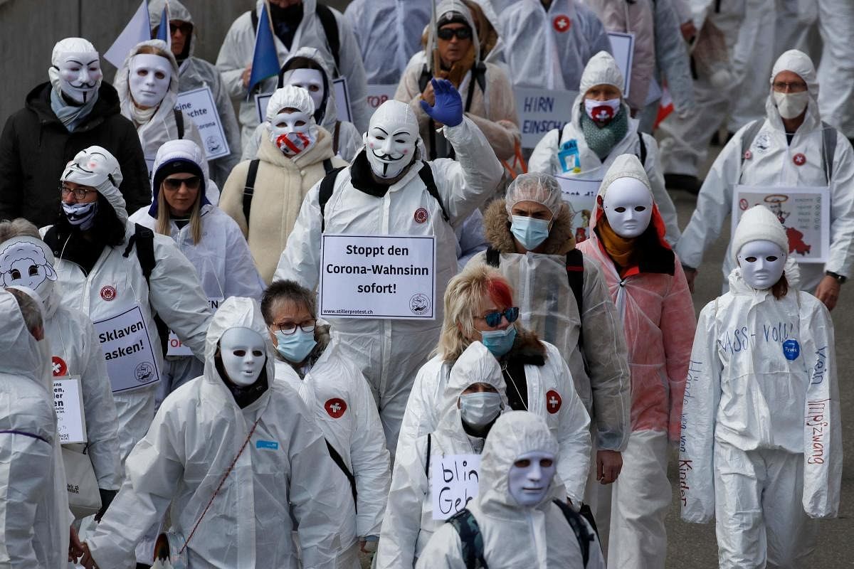 Protesters dressed in white take part in a demonstration against the ongoing coronavirus Covid-19 restrictions in Liestal, near Basel. Credit: AFP Photo