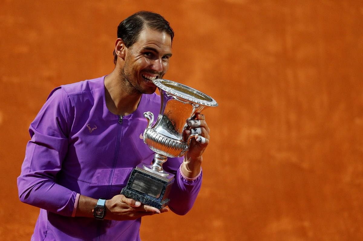Spain's Rafael Nadal celebrates with the trophy after winning his final match against Serbia's Novak Djokovic. Credit: Reuters Photo
