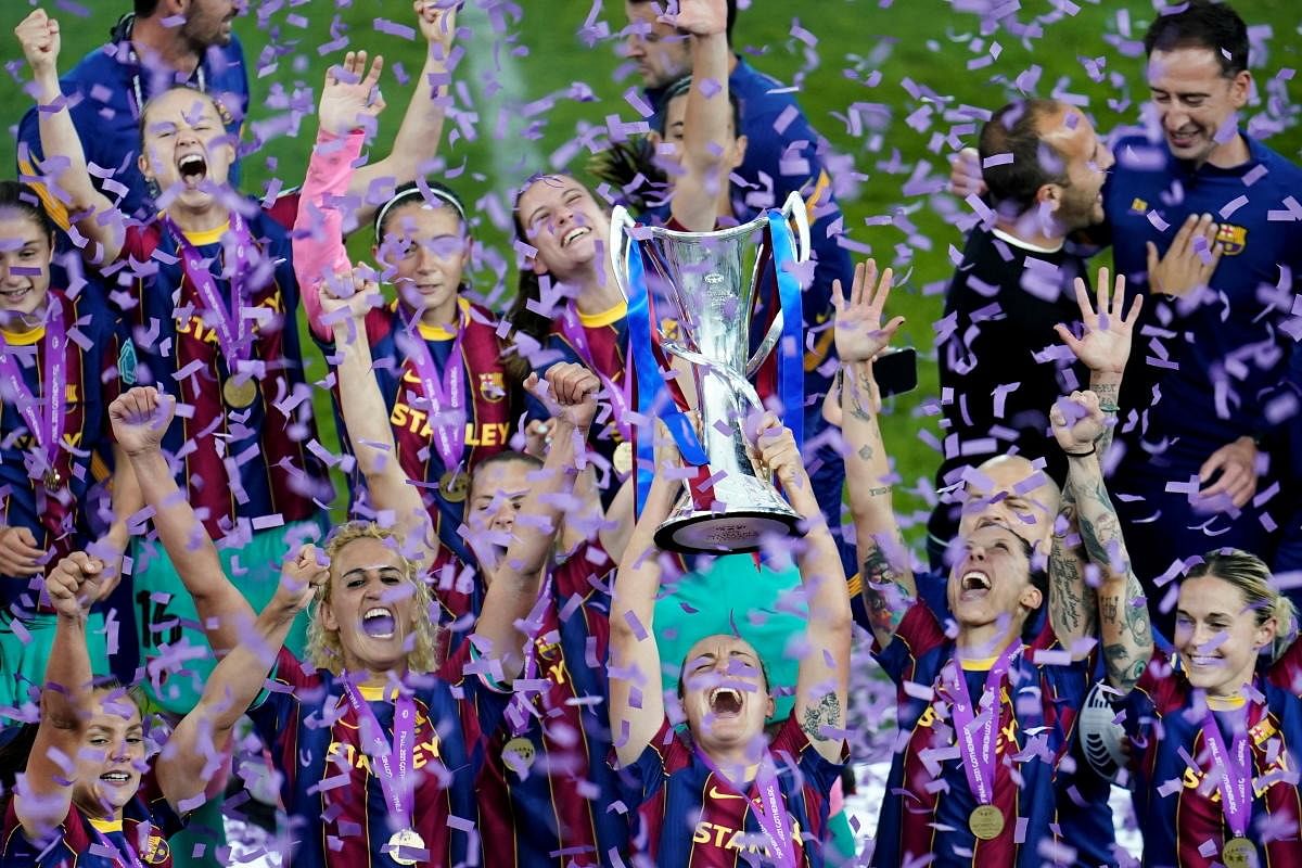 Barcelona players celebrate winning the Women's Champions League Final with the trophy. Credit: Reuters Photo