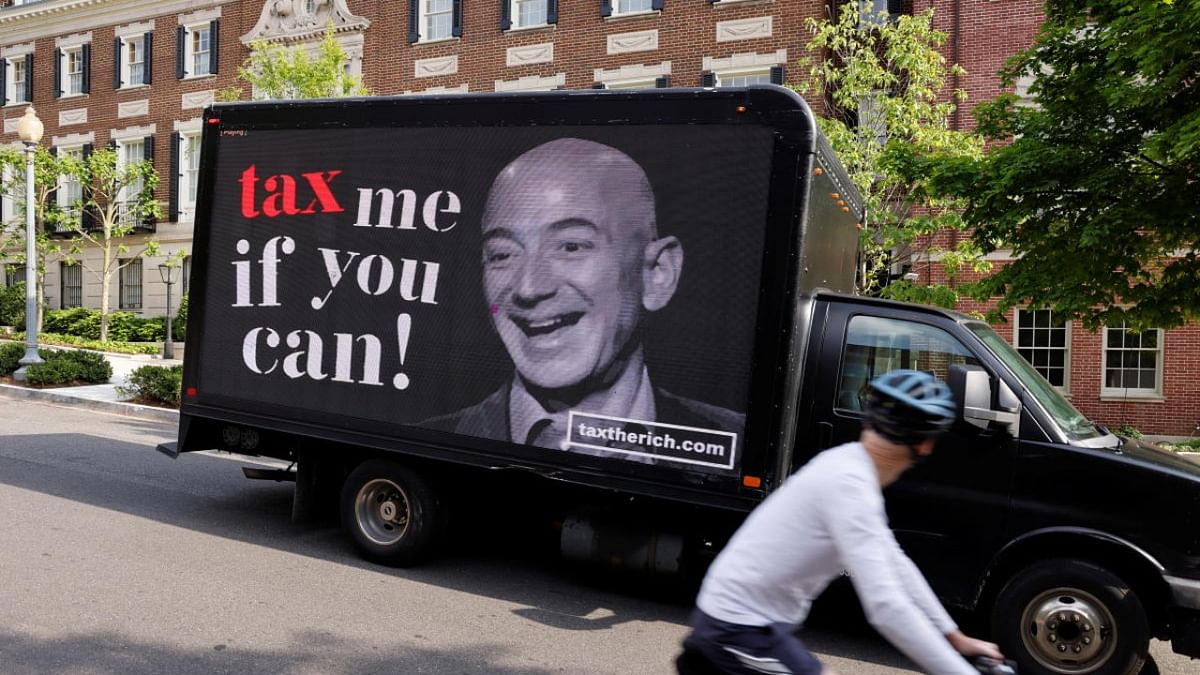 A video protest sign on a truck paid for by the Patriotic Millionaires drives past a mansion owned by Amazon founder Bezos in Washington. Credit: Reuters Photo