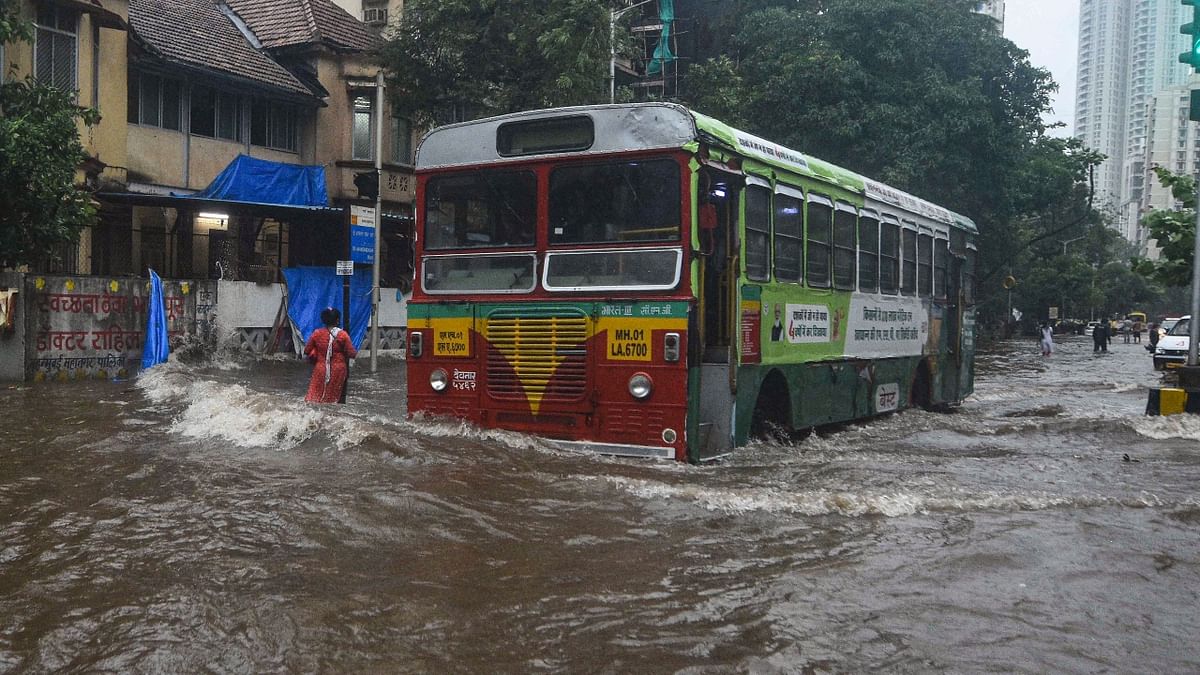 A bus moves through a waterlogged street during Cyclone Tauktae after heavy rains, in Mumbai. Credit: PTI