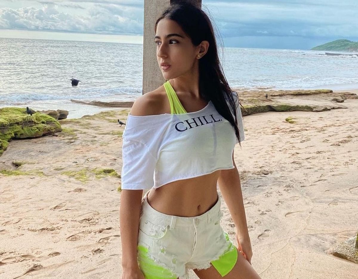 Sara Ali Khan offers major #chillvibes in an off-shoulder crop top with a neon yellow bralette and white denim shorts with matching neon pockets.