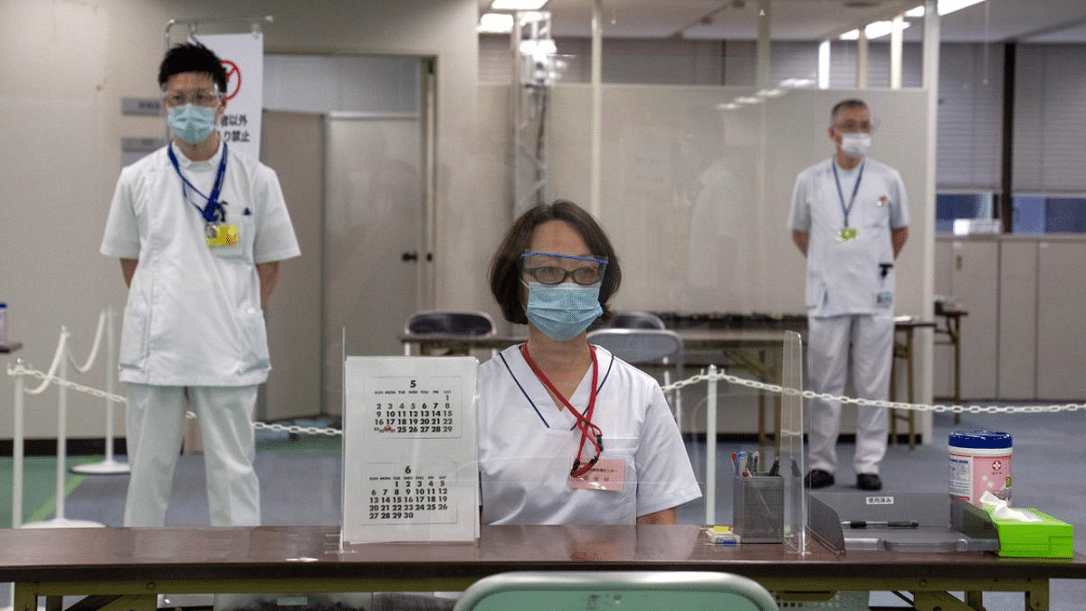 Nurses wait to process people arriving to receive the Moderna coronavirus vaccine at the newly-opened mass vaccination centre in Tokyo, Japan. Credit: Reuters Photo