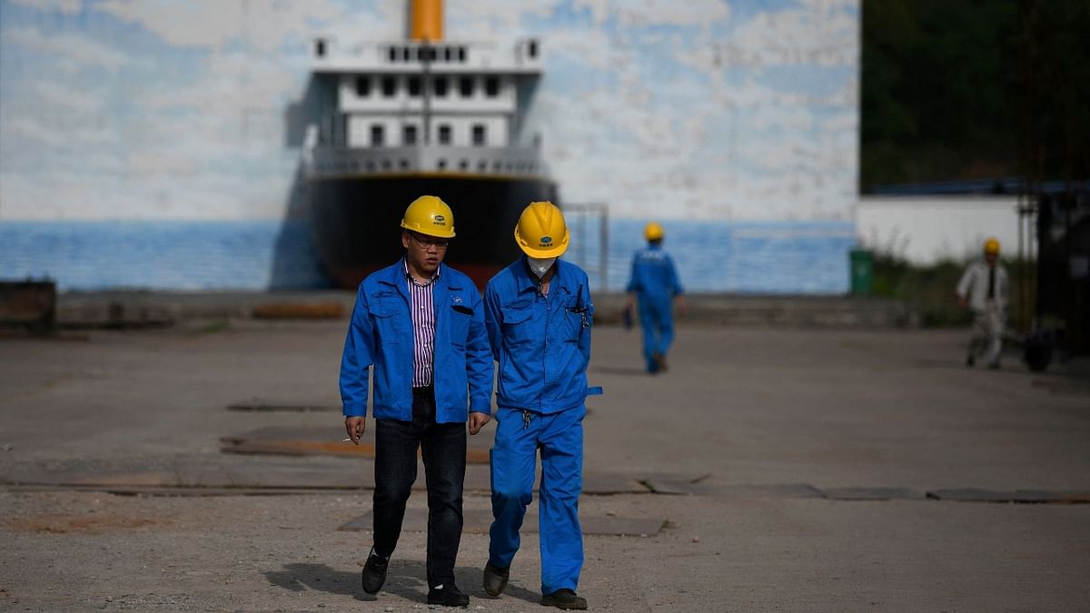 Workers walking at the site of a still-under-construction replica of the Titanic ship in China.