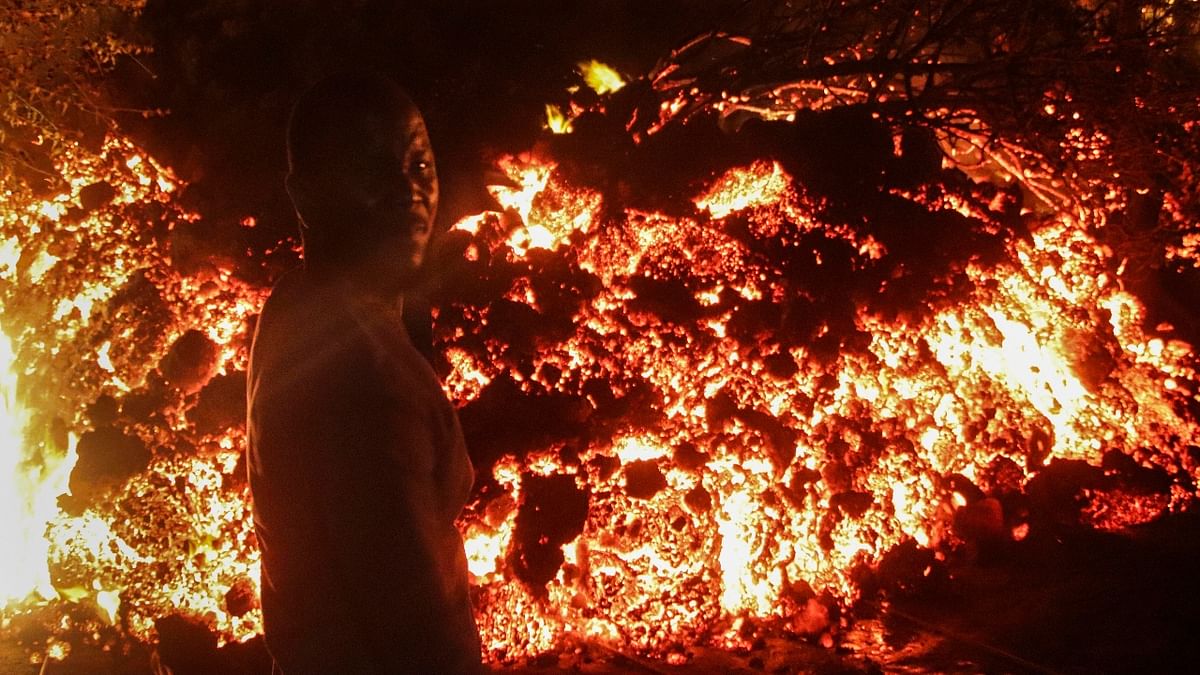 As the red glow of Mount Nyiragongo tinged the night sky above the lakeside city of about 2 million, thousands of Goma residents carrying mattresses and other belongings fled the city on foot - many toward the frontier with Rwanda.