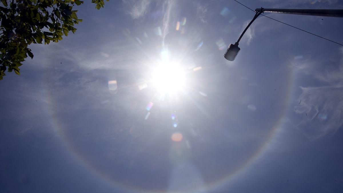 Halos around the sun are caused by the refraction or the splitting of sunlight by ice crystals in the atmosphere. Credit: DH Photo