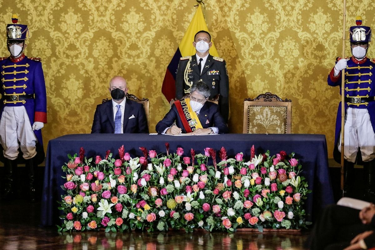 Ecuador’s President Guillermo Lasso signs a document during a presentation of his new cabinet after he is sworn in, at the Carondelet Palace in Quito. Credit: Reuters Photo