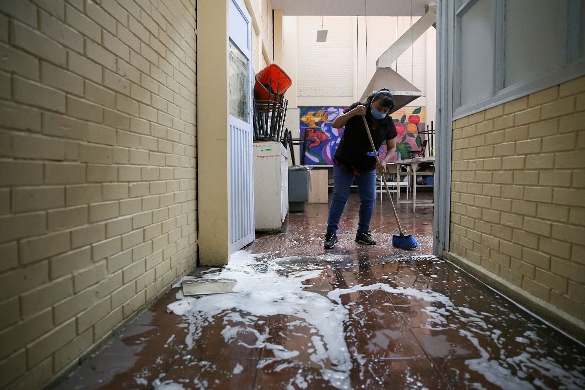A parent cleans a room at Abraham Lincoln school before students go back to class during the reopening of activities amid the spread of the coronavirus disease in Mexico City, Mexico May 22, 2021. Credit: Reuters Photo