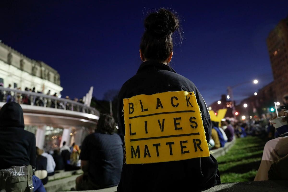 People gather in front of the Brooklyn Museum during a vigil on the first anniversary of the death of George Floyd, in Brooklyn, New York City. Credit: Reuters Photo