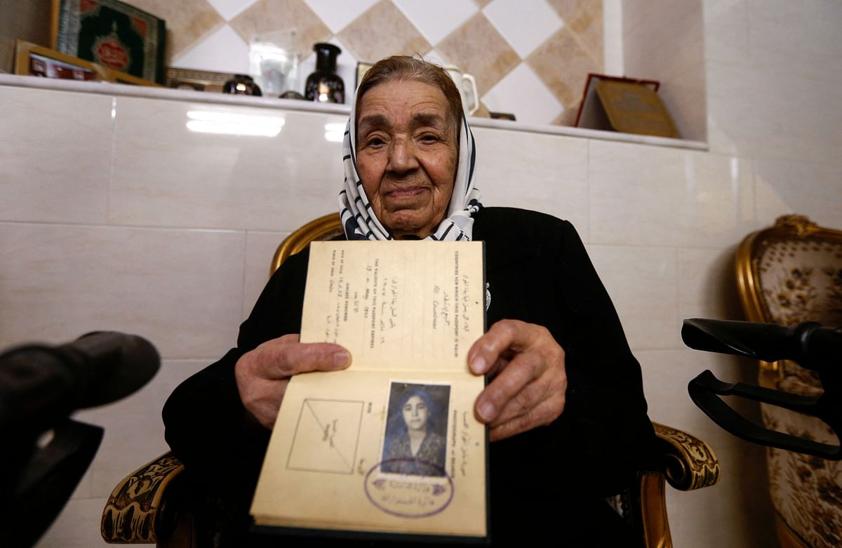 Palestinian refugee Rahma Abdul Qadir Bamiyeh, 85, shows her original travel document at her home in Syria's capital Damascus, on May 22, 2021. Credit: AFP Photo