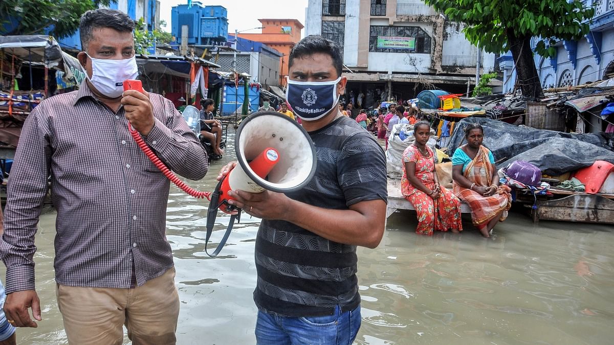Several roads adjoining the sea beaches in Bengal's Digha lay inundated, with some people seen wading through chest-deep water, as the tourist town and its adjoining places bore the brunt of Cyclone Yaas, after it made its landfall in Odisha and West Bengal. Credit: PTI Photo