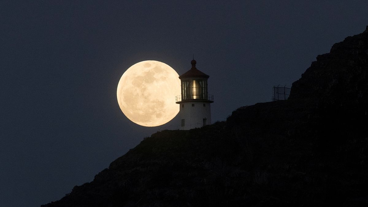 A Super Flower Moon rises over the Makapuu lighthouse in east Oahu, Honolulu, Hawaii, US. Credit: Reuters Photo