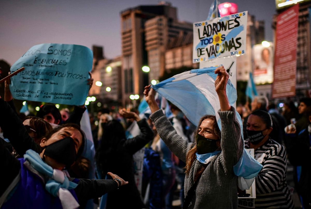 Demonstrators take part in a protest against the lockdown imposed by the government of Argentine President Alberto Fernandez to mitigate the spread of the Covid-19 coronavirus, at 9 de Julio Avenue in Buenos Aires, on May 25, 2021. Credit: AFP Photo