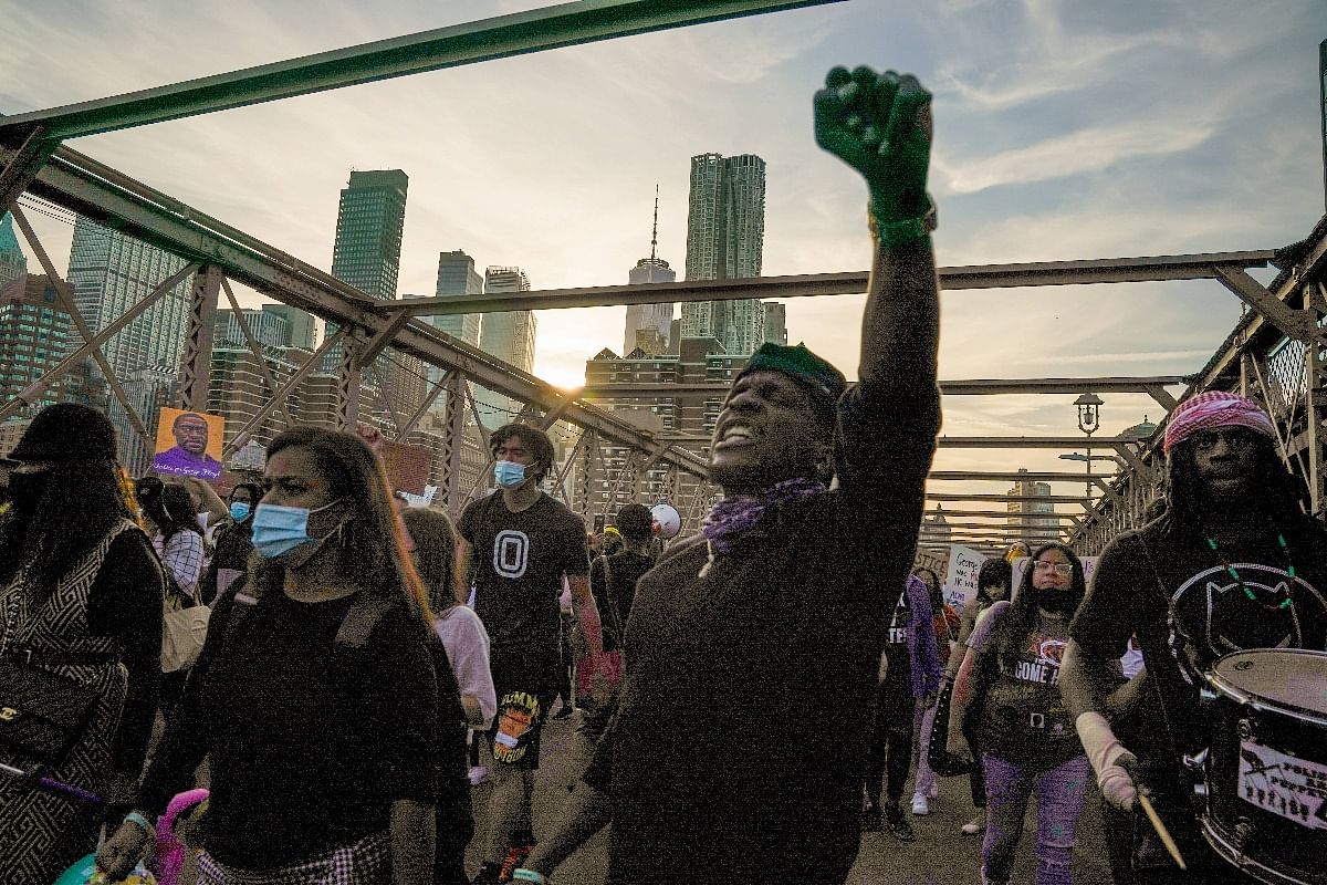 People cross the Brooklyn Bridge demanding police reform after a commemoration to honor the anniversary of George Floyd's death on May 25, 2021, in New York City. Credit: AFP Photo