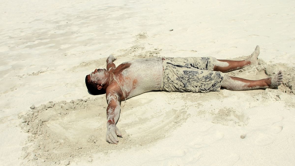Sand Therapy: People around the world visit Cairo to undertake ‘Sand therapy’, wherein people bury themselves under the sand during the hottest time of the day believing it will cure sexual impotency. Credit: Getty Photo