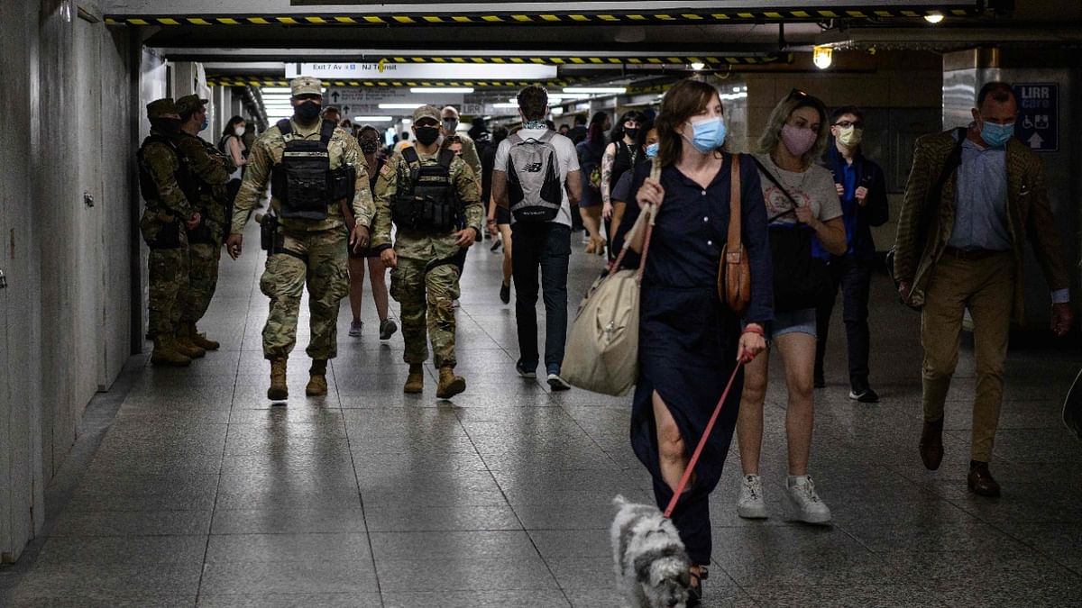 National Guard soldiers and commuters walk through Pennsylvania Station ahead of Memorial Day weekend on May 27, 2021 in New York City. Credit: AFP Photo