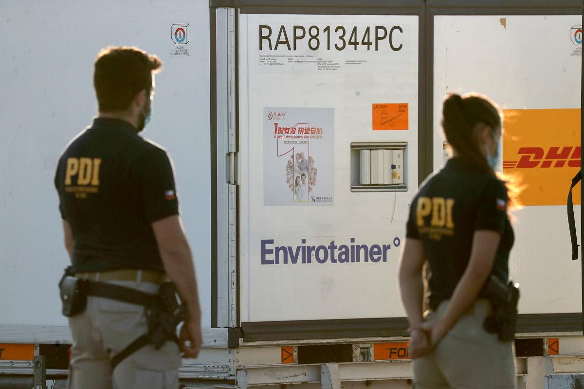 Police members stand guard next to containers transporting the first batch of China's CanSino Covid-19 vaccines at the Arturo Merino Benitez International Airport, as the coronavirus outbreak continues, in Santiago, Chile. Credit: Reuters Photo