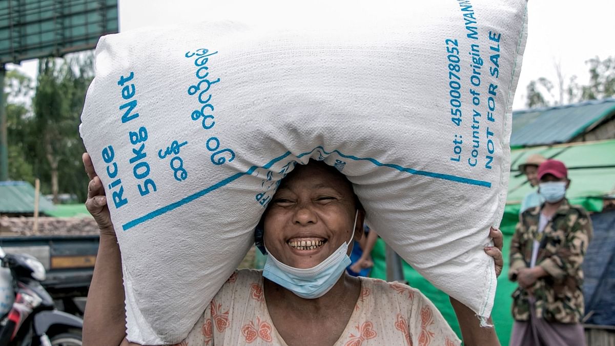 A woman smiles after she received a bag of rice distributed by the World Food Programme (WFP).