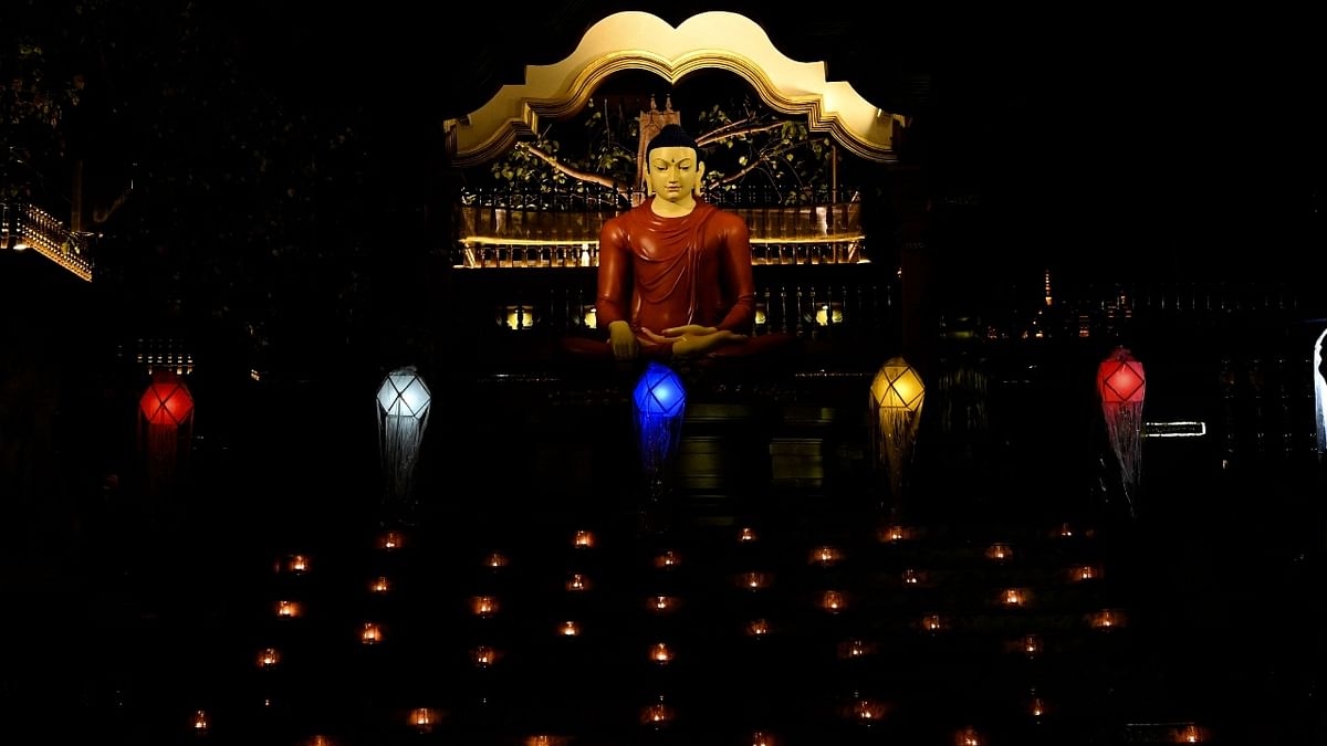 An illuminated statue of Buddha, lit up using lanterns on Vesak Day at the Mahamevnawa Temple in Kaduwela.