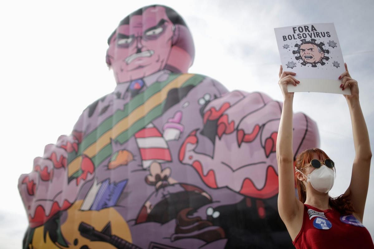A demonstrator holds a banner reading