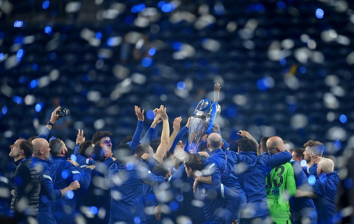 Chelsea players celebrates with the trophy as manager Thomas Tuchel (L) looks on after winning the Champions League. Credit: Reuters Photo