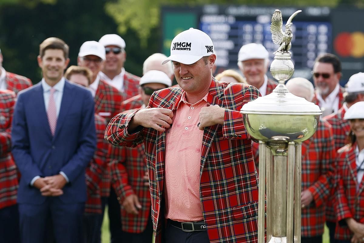 Jason Kokrak celebrates by wearing the Colonial Country Club plaid jacket after winning the 2021 Charles Schwab Challenge. Credit: AFP Photo