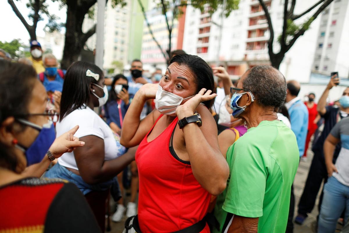 A woman argues as senior citizens and health workers wait to receive their first dose of Russia's Sputnik V vaccine against the coronavirus disease, outside the hotel Alba Caracas, which was turned into a mass vaccination centre, in Caracas, Venezuela. Credit: Reuters Photo