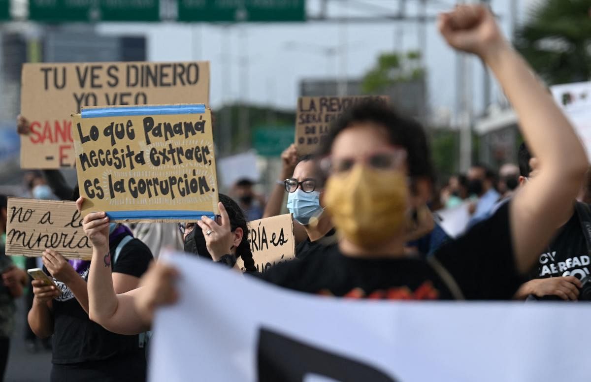 Environmental activists take part in a protest against mining and the government's promotion of the sector as an engine for the recovery of the economy after the severe blow caused by the Covid-19 pandemic, in front of the Ministry of Commerce and Industries of Panama (MICI) in Panama City. Credit: AFP Photo
