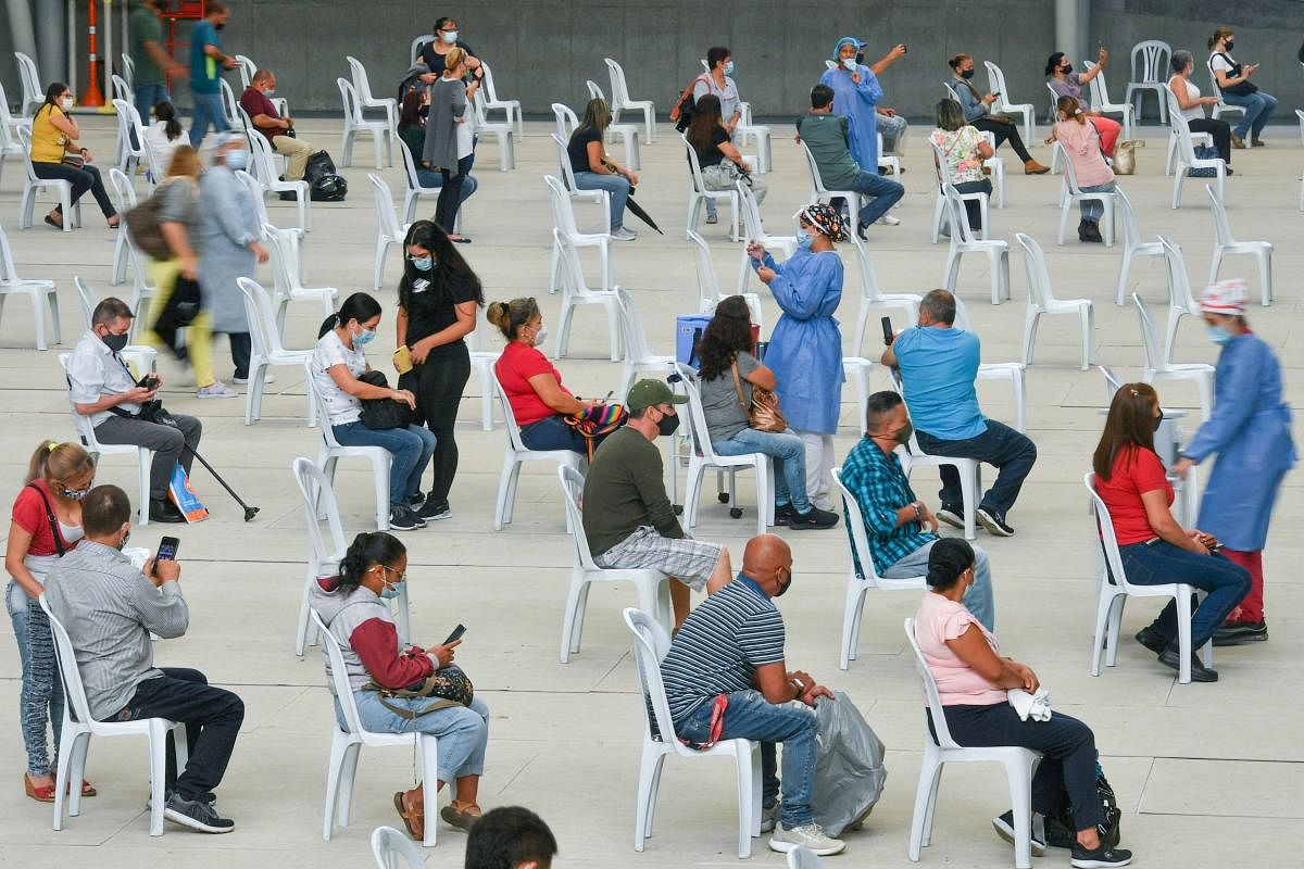 People over 50 years of age are inoculated against Covid-19 at a vaccination centre mounted at a volleyball arena in Medellin, Colombia. Credit: AFP Photo