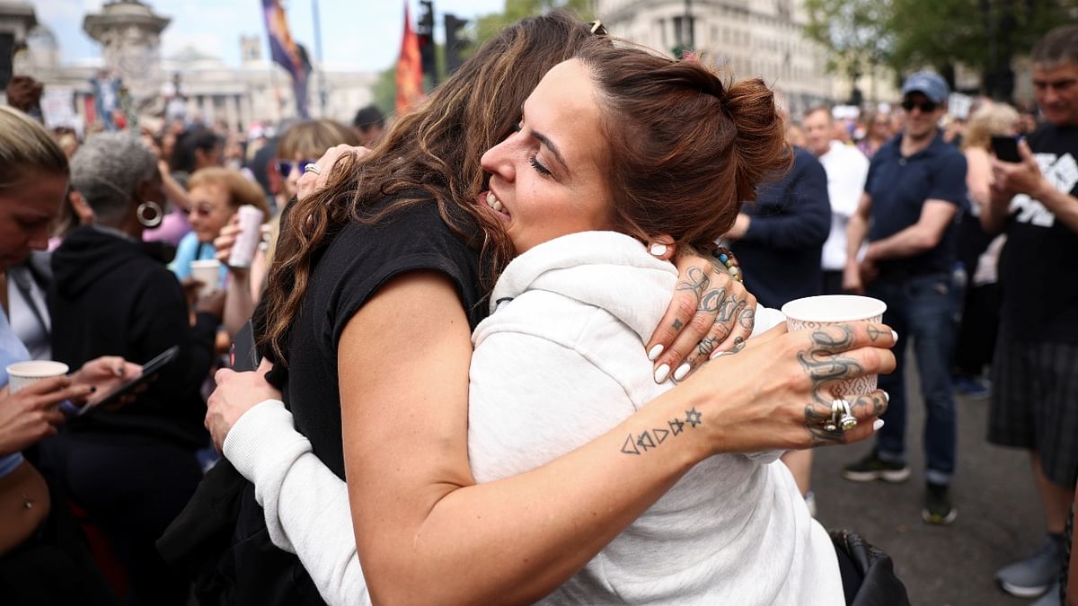 Demonstrators embrace during an anti-lockdown and anti-vaccine protest, amid the spread of the coronavirus disease (Covid-19), in London, Britain.