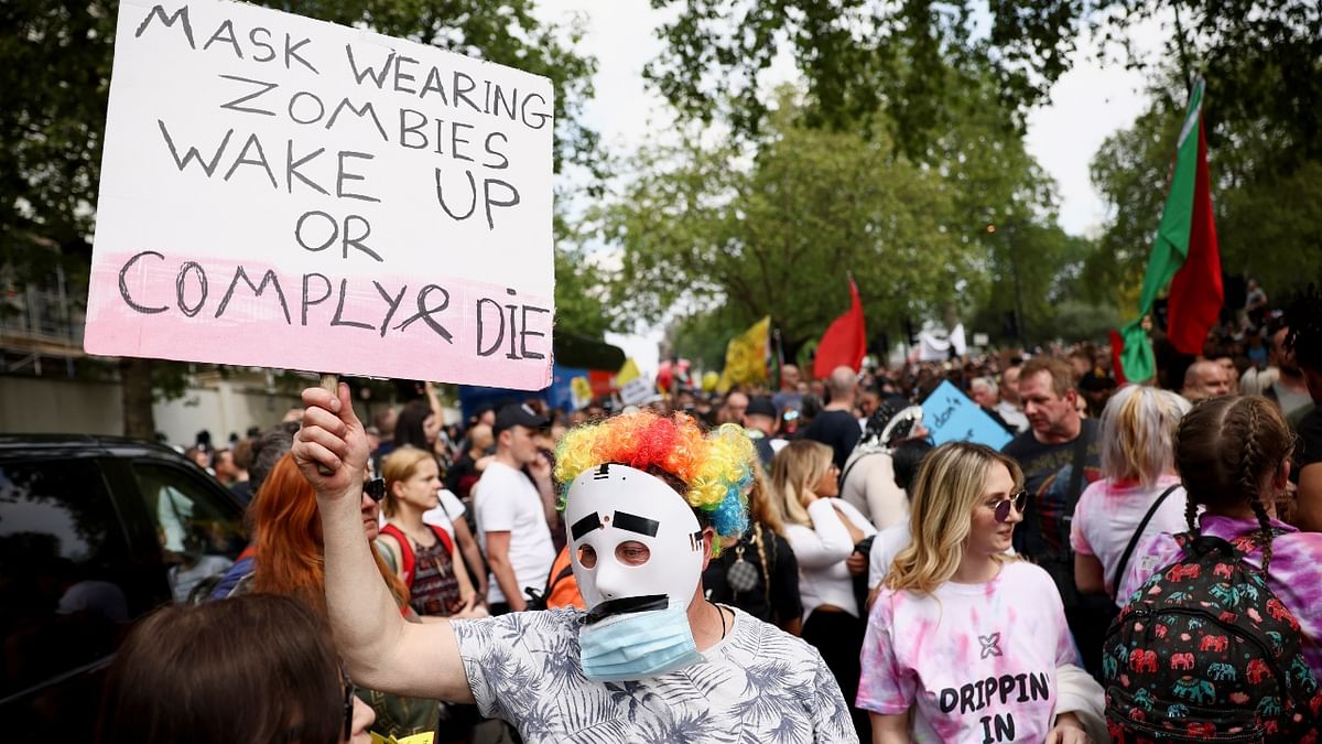 A protestor holds a sign as demonstrators participate in an anti-lockdown and anti-vaccine protest, amid the spread of the coronavirus disease (Covid-19), at Parliament Square in London.