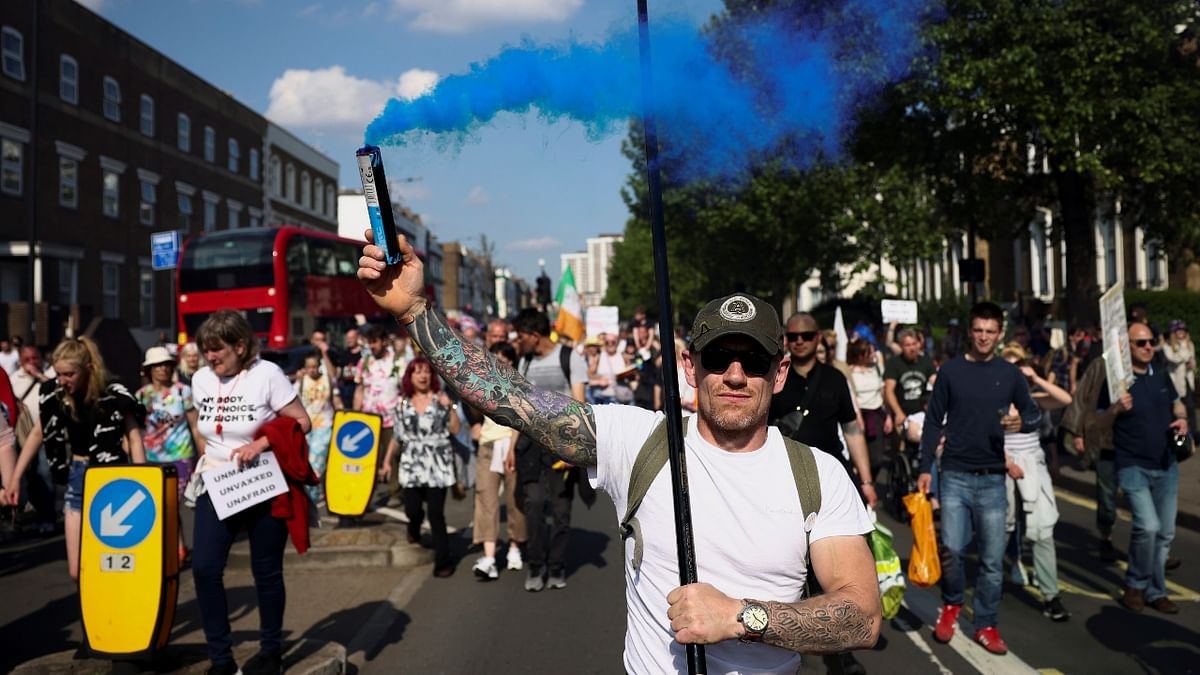 Hundreds of demonstrators parade in an anti-lockdown and anti-vaccine protest in London.