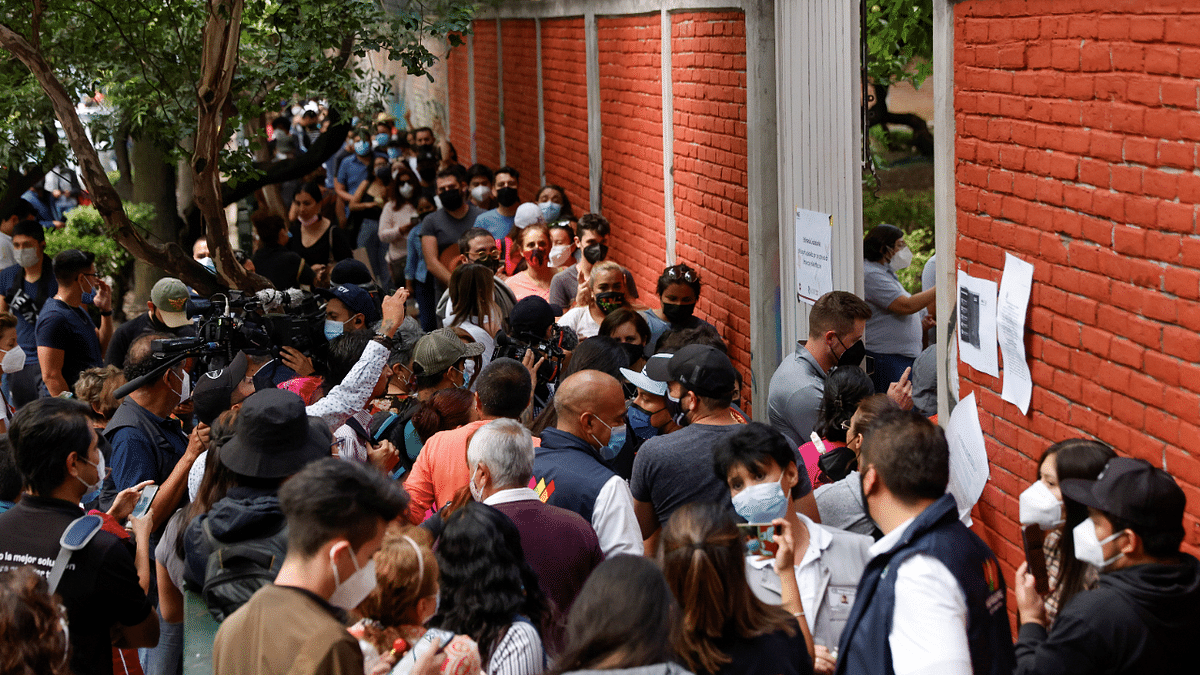 People try to enter to cast their vote minutes before the door closes during mid-term elections in Mexico City. Credit: Reuters Photo