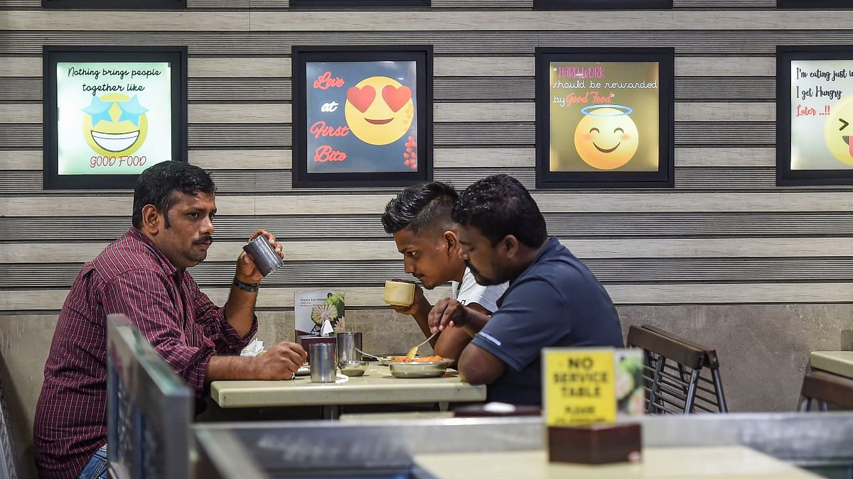 People eat in a restaurant after unlocking of Covid-19 lockdown began, at Sion in Mumbai. Credit: PTI Photo