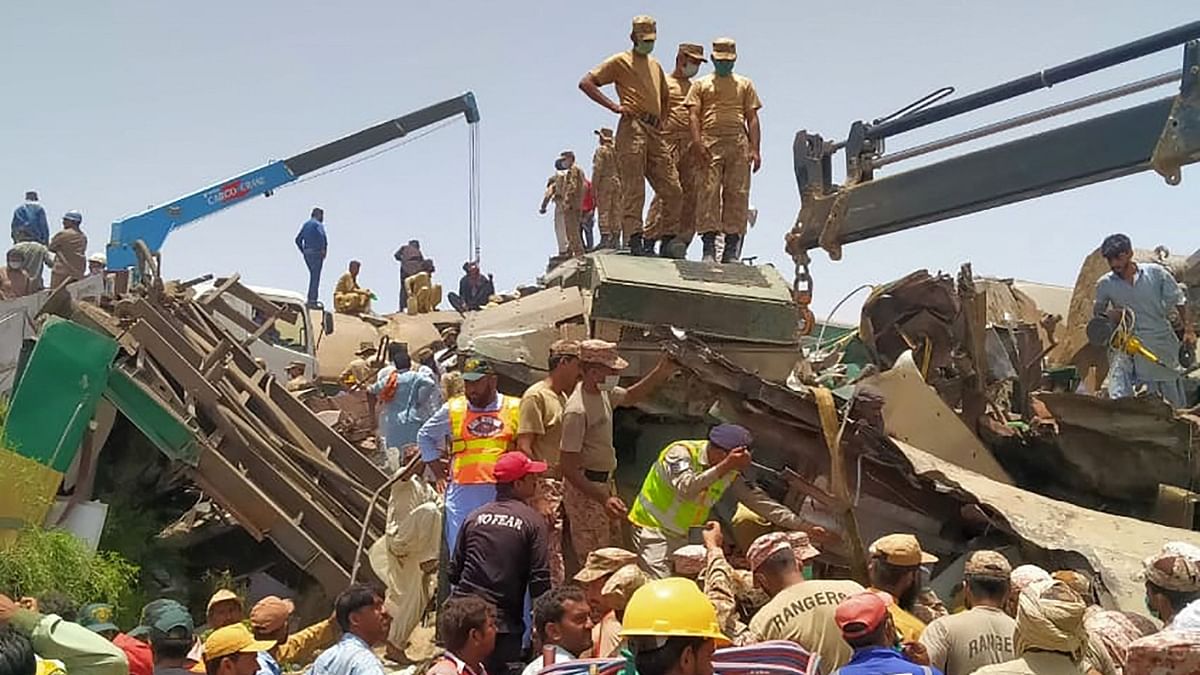The image shows security personnel carrying out rescue operation at the site of the accident in Daharki area of the northern Sindh province. Credit: PTI Photo