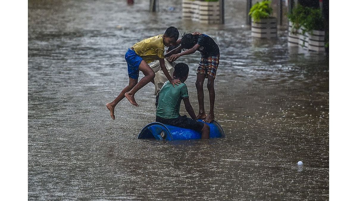 Children play on a flooded street during heavy monsoon rains in Mumbai. Credit: AFP Photo