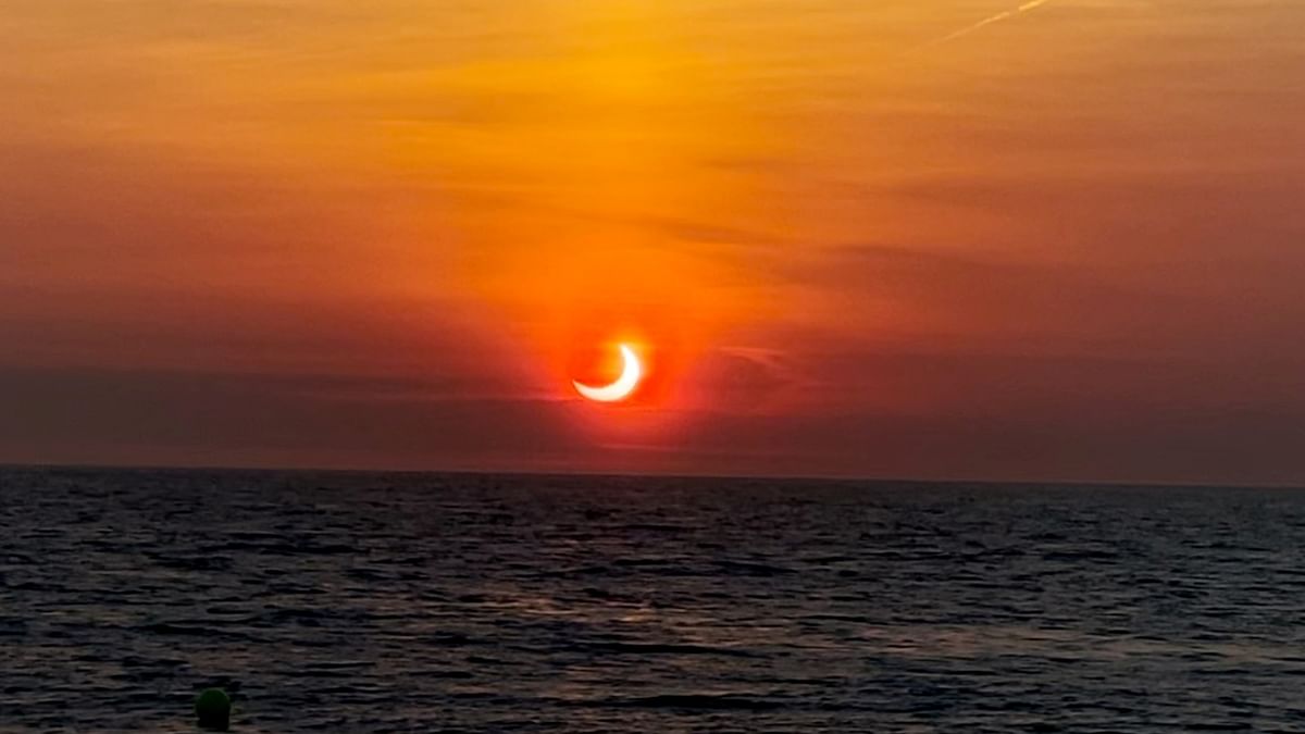 Partial solar eclipse is seen above the horizon in Avon-by-the-Sea, New Jersey, US. Credit: Reuters Photo