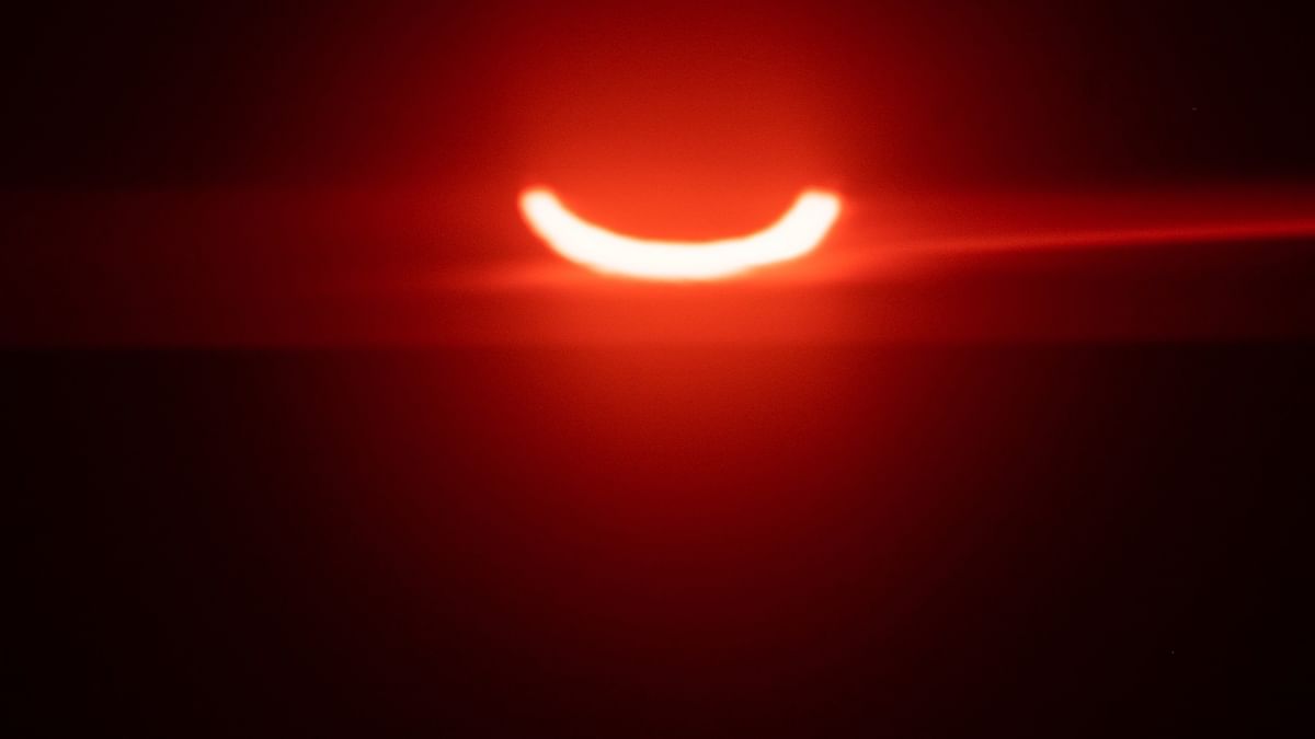 A eclipsed sun rises over Tobermory in Ontario, Canada on June 10, 2021. Credit: AFP Photo