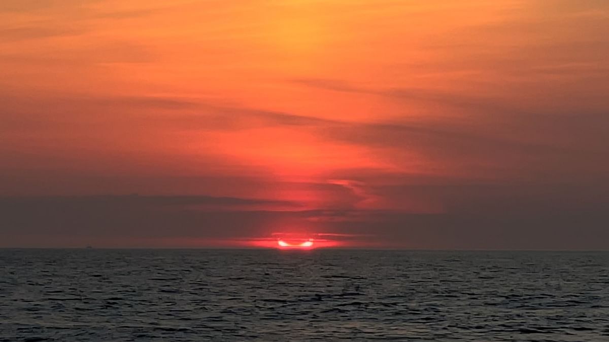 Partial solar eclipse peeks out from the horizon in Avon-by-the-Sea, New Jersey, US. Credit: Reuters Photo