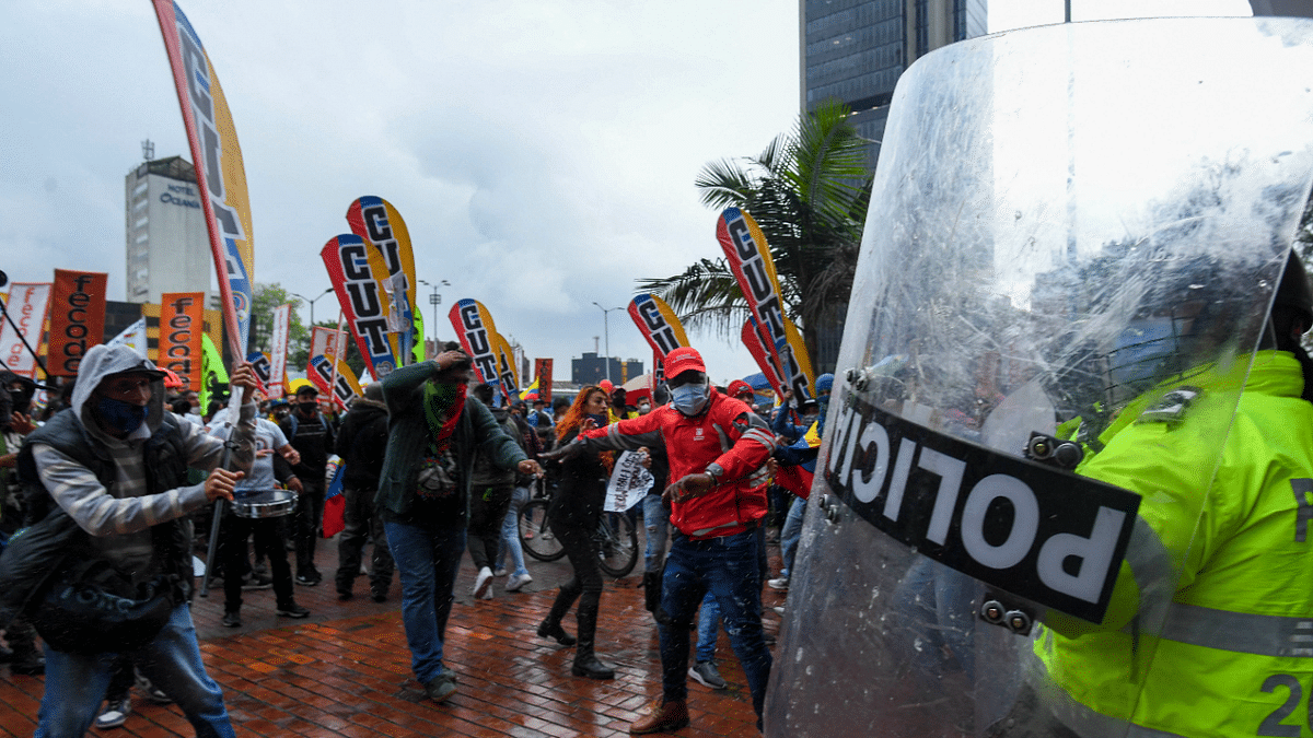 Demonstrators clash with riot police during a protest against the government of Colombian President Ivan Duque outside a hotel where the Inter-American Commission on Human Rights is evaluating if there were abuses by the public forces during previous protests, in Bogota. Credit: AFP Photo