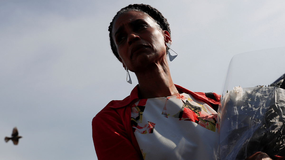 Democratic candidate for New York City Mayor Maya Wiley holds flowers near a makeshift memorial for 10-year-old Justin Wallace. Credit: Reuters Photo