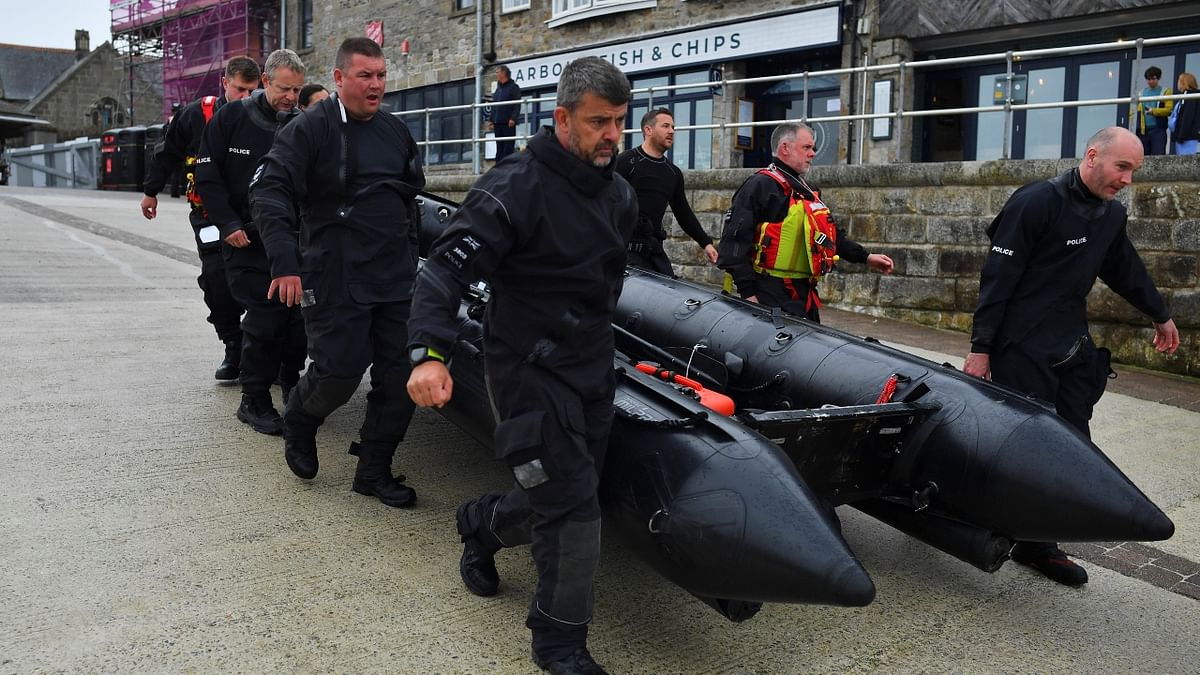 A police marine unit carries a boat in St. Ives as security preparations are underway for the G7 leaders summit, Cornwall, Britain. Credit: Reuters Photo